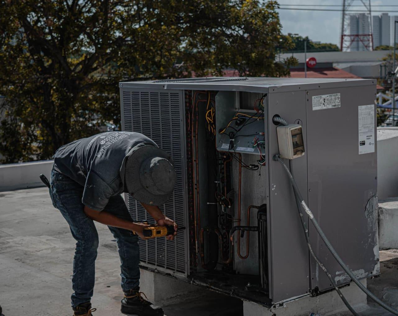 HVAC technician servicing an outdoor condenser unit
